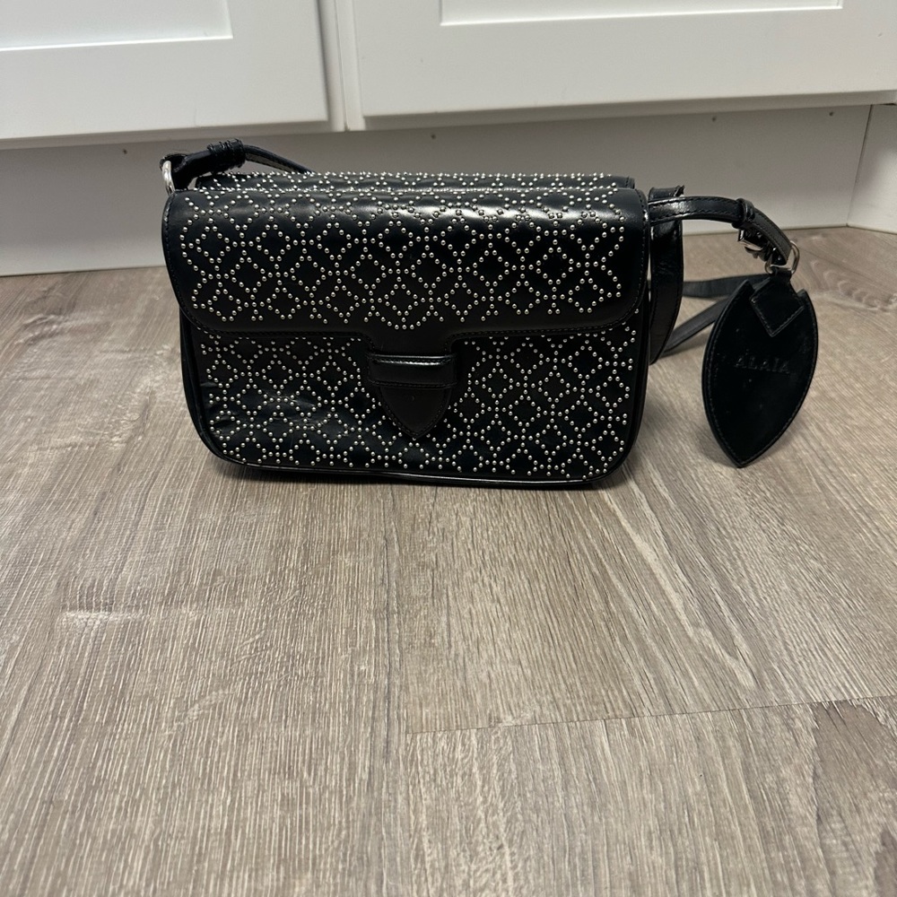 Alaia crossbody bag, black with studs